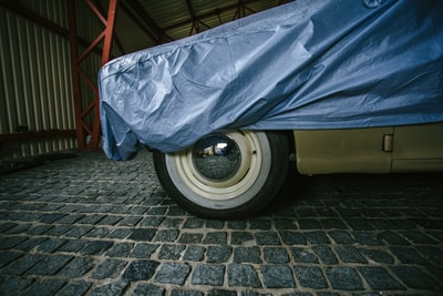 Grey brick floor of the blue car hood
